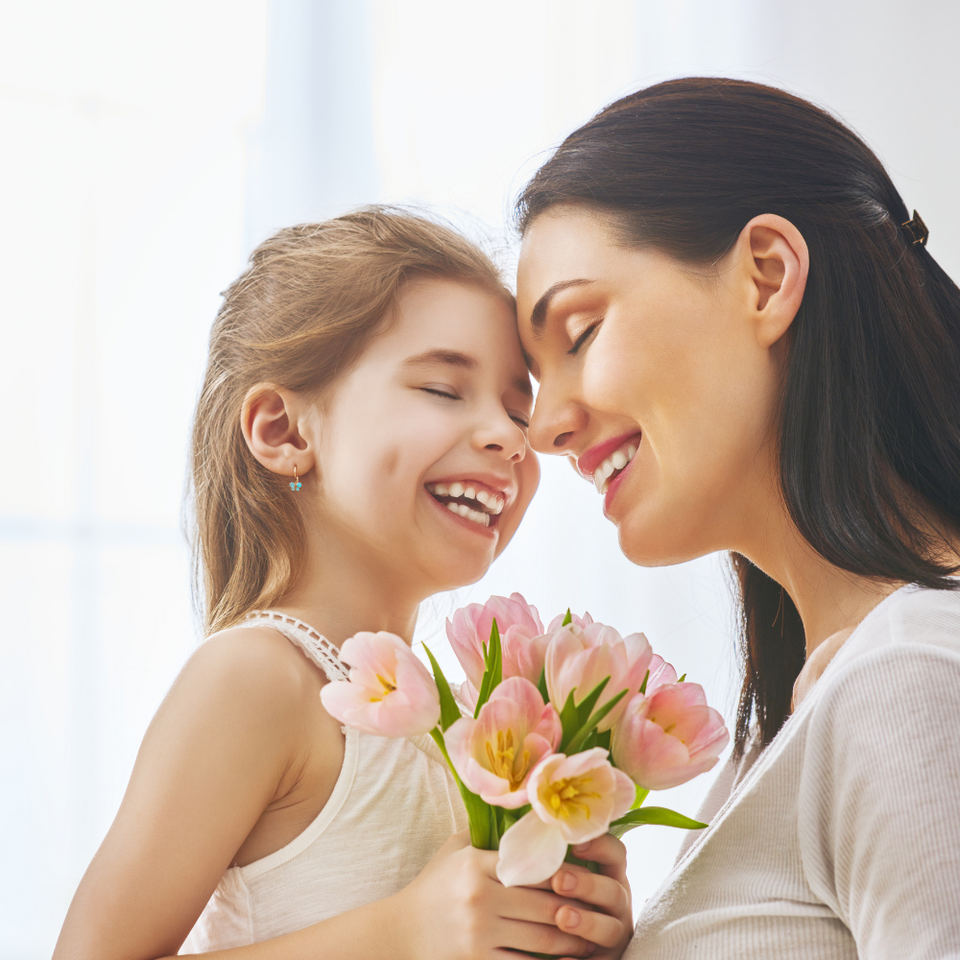 woman and a child holding flowers