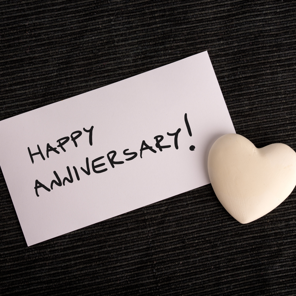 a white card that says happy Anniversary